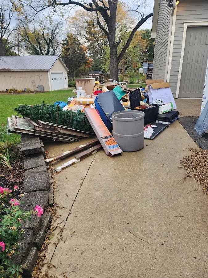 Dumpster being loaded with debris for 30 Yard Dumpster Rental in League City
